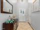 Bright and spacious entryway with decorative mirror and storage cabinet at 980 S 220Th Ln, Buckeye, AZ 85326