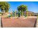 Modern playground with slides and climbing equipment in a sandy play area at 980 S 220Th Ln, Buckeye, AZ 85326