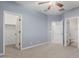 Bedroom with light blue walls, ceiling fan and closet at 18657 E Pine Barrens Ave, Queen Creek, AZ 85142