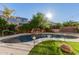 Sparkling kidney-shaped pool with a rock waterfall feature at 18657 E Pine Barrens Ave, Queen Creek, AZ 85142