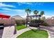 Landscaped backyard featuring a hot tub and pergola at 45075 W Gavilan Dr, Maricopa, AZ 85139