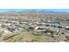 Community overview: many houses with solar panels and a lake at 16918 S 180Th Dr, Goodyear, AZ 85338
