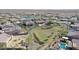 Aerial view of community, showcasing houses, a lake, and green space at 16918 S 180Th Dr, Goodyear, AZ 85338