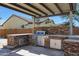 Outdoor kitchen with grill, stone countertops, and cabinets at 16918 S 180Th Dr, Goodyear, AZ 85338
