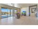 Living room features wood-look floors, sliding glass doors to backyard, and pool view at 16918 S 180Th Dr, Goodyear, AZ 85338