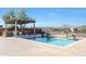Inviting backyard oasis featuring a sparkling pool, built-in barbecue, and pergola at 16918 S 180Th Dr, Goodyear, AZ 85338
