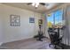 Home office with window, desk, chair, and exercise equipment at 16918 S 180Th Dr, Goodyear, AZ 85338