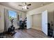 Home office features hardwood floors, built-in shelving, and a large window at 16918 S 180Th Dr, Goodyear, AZ 85338