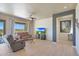 Bright living room with wood-look floors, comfy furniture, and sliding glass doors leading to a patio at 16918 S 180Th Dr, Goodyear, AZ 85338