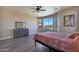 Bright bedroom with large windows, a dresser, and a comfortable bed at 16918 S 180Th Dr, Goodyear, AZ 85338