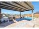 Covered patio with built-in grill and bar overlooking pool at 16918 S 180Th Dr, Goodyear, AZ 85338