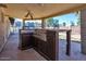 Covered patio with built-in grilling station and cabinets at 15402 N 56Th Ave, Glendale, AZ 85306