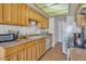 Bright kitchen with wood cabinets and white backsplash at 15402 N 56Th Ave, Glendale, AZ 85306