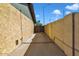 Side yard access with concrete pathway and a wooden gate at 15402 N 56Th Ave, Glendale, AZ 85306