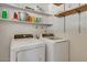 Laundry room with washer, dryer and shelving at 15402 N 56Th Ave, Glendale, AZ 85306