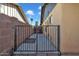 Side yard access with a metal gate and concrete pathway at 15402 N 56Th Ave, Glendale, AZ 85306