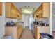 Bright kitchen with light wood cabinets and tile floor at 15402 N 56Th Ave, Glendale, AZ 85306
