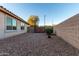 Backyard with a gate and rock landscaping at 22939 W Morning Glory St, Buckeye, AZ 85326