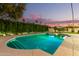 Inviting swimming pool with a tranquil ambiance at dusk at 8675 E Thoroughbred Trl, Scottsdale, AZ 85258