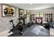 Well-equipped home gym with exercise bike, weights, and storage at 8675 E Thoroughbred Trl, Scottsdale, AZ 85258