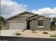 Single-story house with two-car garage and desert landscaping at 11626 N Stanton Ln, Maricopa, AZ 85139