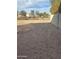 Backyard with gravel and partially fenced area at 9406 W Elwood St, Tolleson, AZ 85353