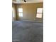 Primary bedroom with carpeted floor and multiple windows at 9406 W Elwood St, Tolleson, AZ 85353