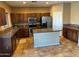 Spacious kitchen with island, granite counters, and stainless steel appliances at 9406 W Elwood St, Tolleson, AZ 85353