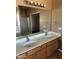 Double vanity bathroom with a large mirror and shower at 9406 W Elwood St, Tolleson, AZ 85353
