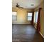 Bright living room featuring wood-look floors and ceiling fan at 9406 W Elwood St, Tolleson, AZ 85353