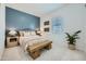 Serene bedroom with a wooden bench and a blue accent wall at 947 W Saddle Run, Apache Junction, AZ 85120