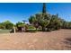 Landscaped grounds with mature trees and gravel areas at 2300 E Sanoque Ct, Gilbert, AZ 85298