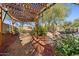 Wooden pergola in the backyard with lush landscaping at 36908 N 19Th St, Phoenix, AZ 85086