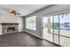 Bright Gathering room with fireplace and sliding glass doors leading to a patio with water view at 20382 N 53Rd Ave, Glendale, AZ 85308