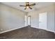 Bright bedroom with dark wood-look floors and ceiling fan at 20382 N 53Rd Ave, Glendale, AZ 85308