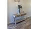 Light and bright entryway with console table and wood-look floors at 13567 N 142Nd Ave, Surprise, AZ 85379