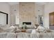 Living room featuring a floor-to-ceiling stone fireplace and plush seating at 4132 N 44Th Pl, Phoenix, AZ 85018