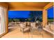 Evening view of a covered patio with comfortable seating at 7082 E Palo Brea Dr, Gold Canyon, AZ 85118