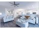 Spacious living room featuring light gray sofas and a fireplace at 7082 E Palo Brea Dr, Gold Canyon, AZ 85118