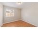 Simple bedroom with wood flooring and a window with blinds at 2867 W Muriel Dr, Phoenix, AZ 85053