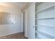 Spacious bedroom closet with open shelving and mirrored wall art at 2222 E Arabian Dr, Gilbert, AZ 85296