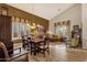 Bright dining area with a large table, hardwood floors, and access to the living room at 15439 E Acacia Way, Fountain Hills, AZ 85268