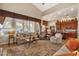 Spacious living room showcasing hardwood floors, a fireplace, and views to the kitchen at 15439 E Acacia Way, Fountain Hills, AZ 85268