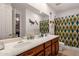 Bathroom with double sinks, shower, and teal accents at 15439 E Acacia Way, Fountain Hills, AZ 85268