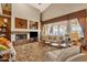 Relaxing living room with a fireplace, comfortable seating, and plenty of natural light at 15439 E Acacia Way, Fountain Hills, AZ 85268