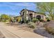 Two-story house with desert landscaping, three-car garage, and a walkway to the entry at 15439 E Acacia Way, Fountain Hills, AZ 85268