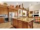 Island kitchen with granite countertops, stainless steel appliances, and ample cabinet space at 15439 E Acacia Way, Fountain Hills, AZ 85268