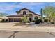 Two-story house with desert landscaping, three-car garage, and a walkway to the entry at 15439 E Acacia Way, Fountain Hills, AZ 85268