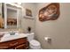 Clean bathroom with wood vanity, toilet and decorative art at 15439 E Acacia Way, Fountain Hills, AZ 85268