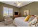 Bedroom with a queen bed, comfy armchair, and mountain view at 15439 E Acacia Way, Fountain Hills, AZ 85268